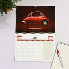 Load image into Gallery viewer, Calendar with a red car design on a white surface with a pen and notebook.
